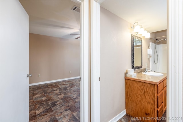 609 Lakeshore Dr, Durant, OK 74701 - bathroom featuring vanity, stone finish flooring, and ceiling fan