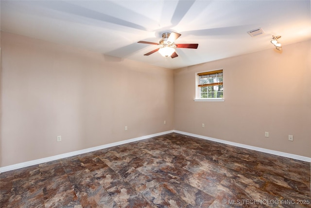 609 Lakeshore Dr, Durant, OK 74701 - empty room featuring a ceiling fan and stone finish floors
