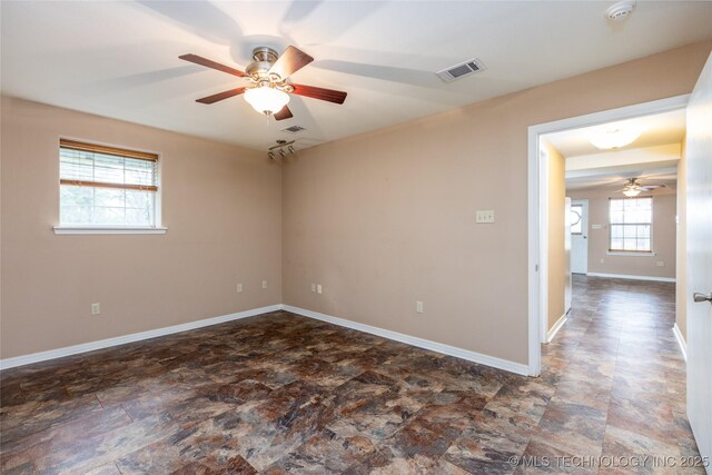 609 Lakeshore Dr, Durant, OK 74701 - spare room with a ceiling fan, stone finish flooring, and a smoke detector