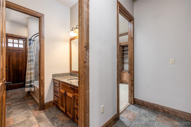 609 Lakeshore Dr, Durant, OK 74701 - bathroom with stone finish floors, vanity, and shower / bath combo
