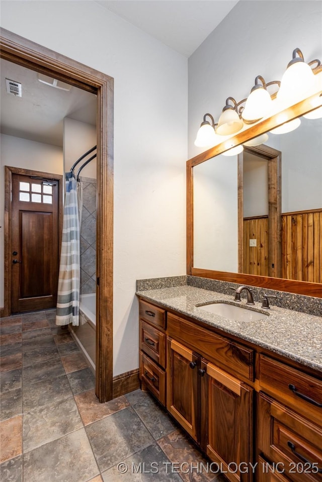 609 Lakeshore Dr, Durant, OK 74701 - full bath featuring vanity, stone finish floors, and shower / bath combo