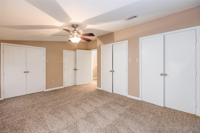 609 Lakeshore Dr, Durant, OK 74701 - unfurnished bedroom with multiple closets, carpet, and ceiling fan