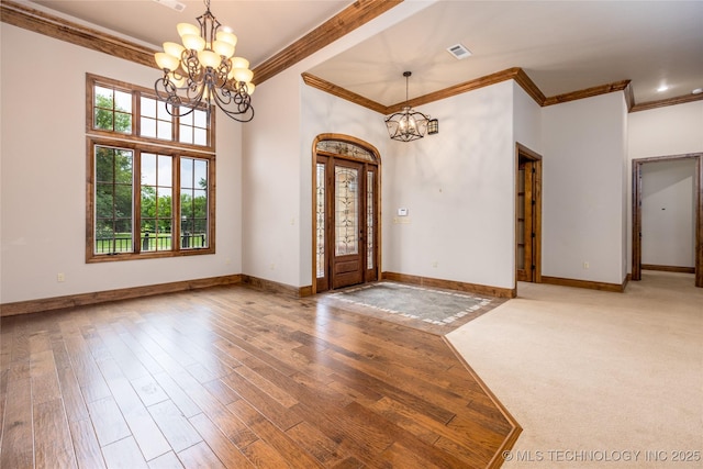 609 Lakeshore Dr, Durant, OK 74701 - foyer entrance with a chandelier, ornamental molding, and wood finished floors