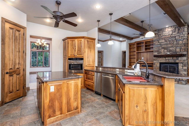 609 Lakeshore Dr, Durant, OK 74701 - kitchen with ceiling fan, stainless steel appliances, a kitchen island, beam ceiling, and dark stone countertops