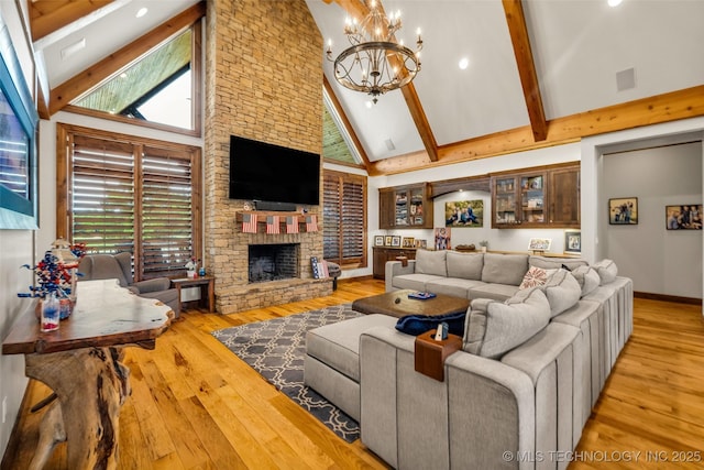 13533 S Lewis Ave, Bixby, OK 74008 - living room with high vaulted ceiling, hardwood / wood-style floors, a chandelier, a stone fireplace, and beamed ceiling