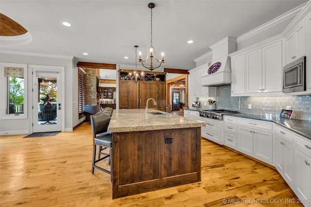 13533 S Lewis Ave, Bixby, OK 74008 - kitchen with ornamental molding, stainless steel appliances, a chandelier, tasteful backsplash, and white cabinetry