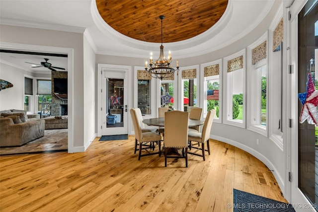 13533 S Lewis Ave, Bixby, OK 74008 - dining space featuring ornamental molding, light wood-style flooring, a chandelier, a raised ceiling, and a fireplace
