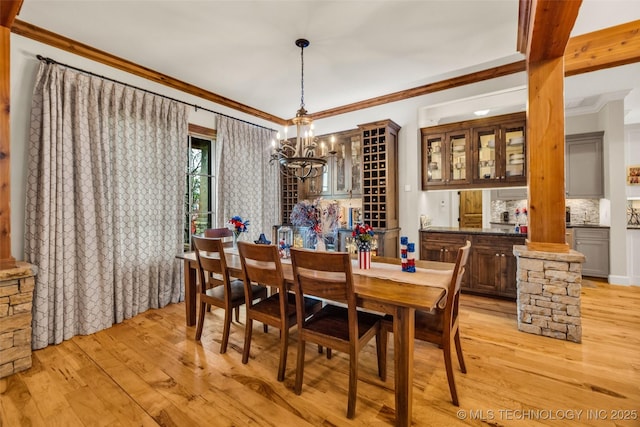 13533 S Lewis Ave, Bixby, OK 74008 - dining space featuring a chandelier, light wood-style flooring, ornamental molding, and decorative columns