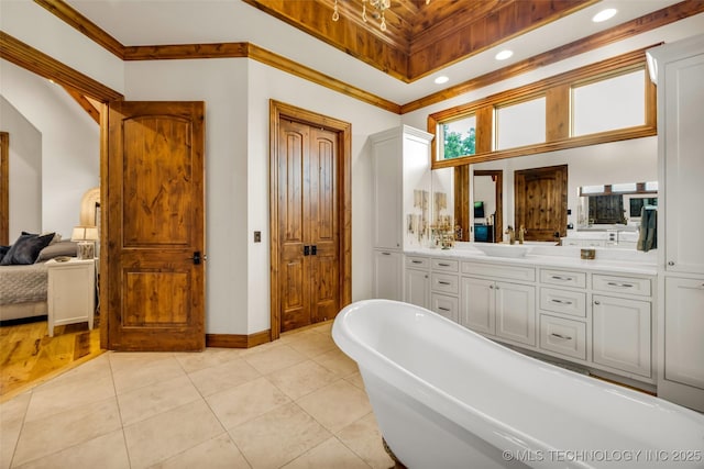 13533 S Lewis Ave, Bixby, OK 74008 - bathroom featuring a freestanding bath, vanity, tile patterned flooring, ornamental molding, and recessed lighting