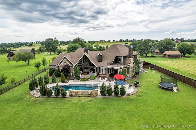 13533 S Lewis Ave, Bixby, OK 74008 - rear view of property featuring a trampoline, a balcony, a fenced backyard, a chimney, and a patio