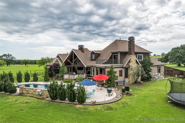 13533 S Lewis Ave, Bixby, OK 74008 - back of house featuring a balcony, a chimney, a patio area, and a fenced backyard