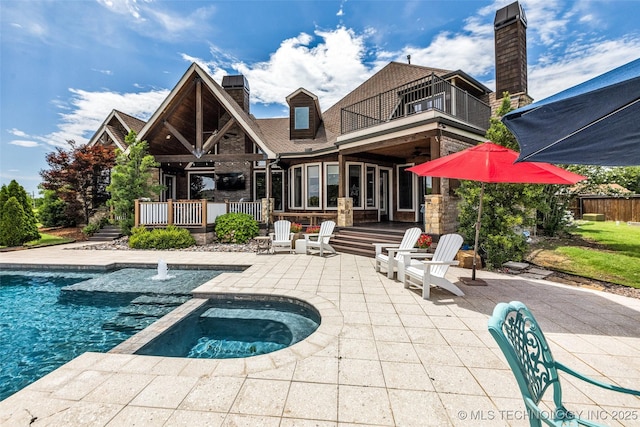 13533 S Lewis Ave, Bixby, OK 74008 - back of house featuring a balcony, a chimney, a patio area, a pool with connected hot tub, and roof with shingles