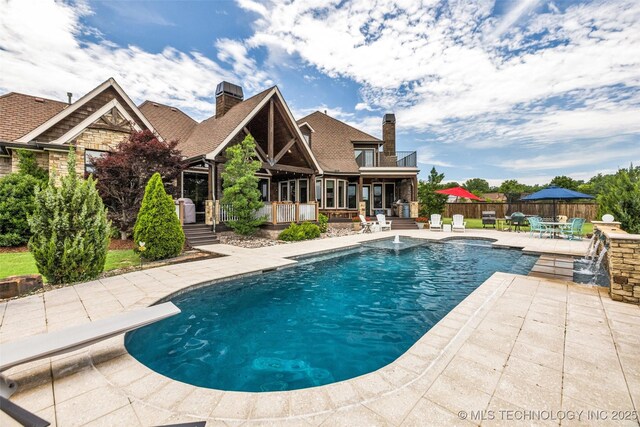 13533 S Lewis Ave, Bixby, OK 74008 - view of swimming pool featuring a patio area, a diving board, and outdoor dining area