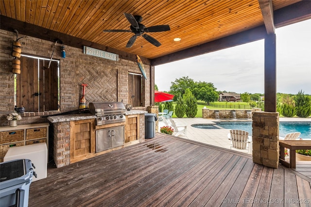 13533 S Lewis Ave, Bixby, OK 74008 - wooden terrace featuring exterior kitchen, a ceiling fan, an outdoor pool, and a patio