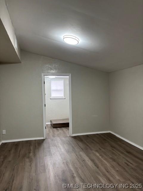 1200 S Mckinley Ave, Calera, OK 74730 - unfurnished room featuring wood finished floors and vaulted ceiling