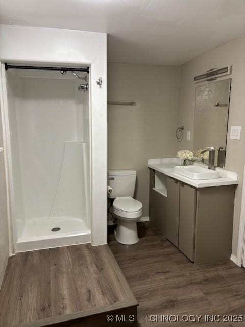 1200 S Mckinley Ave, Calera, OK 74730 - bathroom featuring wood finished floors, vanity, and a shower
