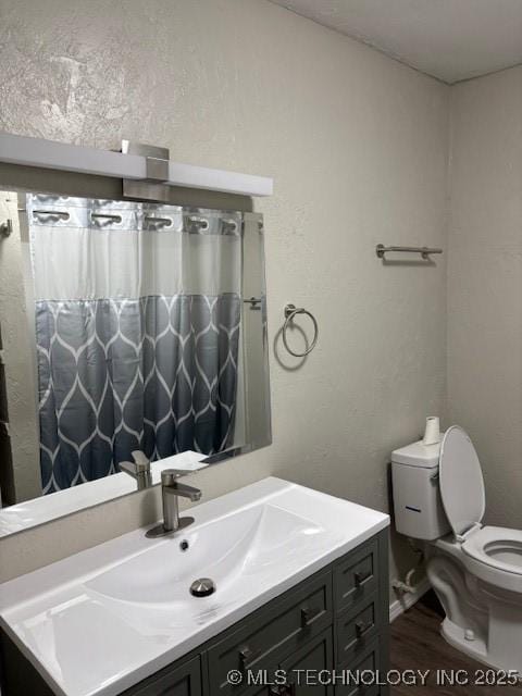 1200 S Mckinley Ave, Calera, OK 74730 - full bathroom featuring vanity and wood finished floors