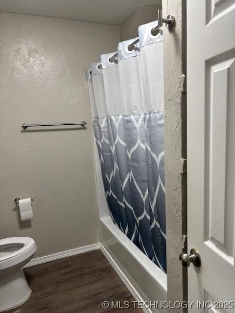 1200 S Mckinley Ave, Calera, OK 74730 - full bathroom featuring wood finished floors and shower / bath combo with shower curtain