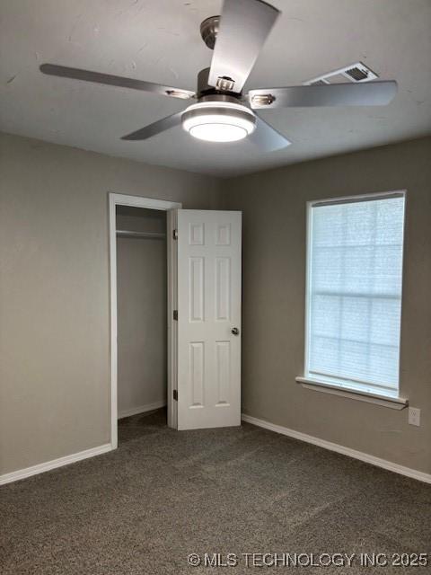 1200 S Mckinley Ave, Calera, OK 74730 - unfurnished bedroom featuring carpet flooring, a closet, and a ceiling fan