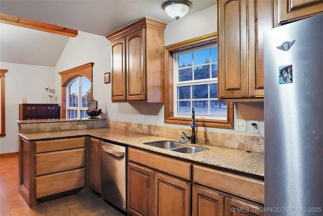 740384 S 3480th Rd, Cushing, OK 74023 - kitchen with freestanding refrigerator, stainless steel dishwasher, a peninsula, light stone countertops, and vaulted ceiling