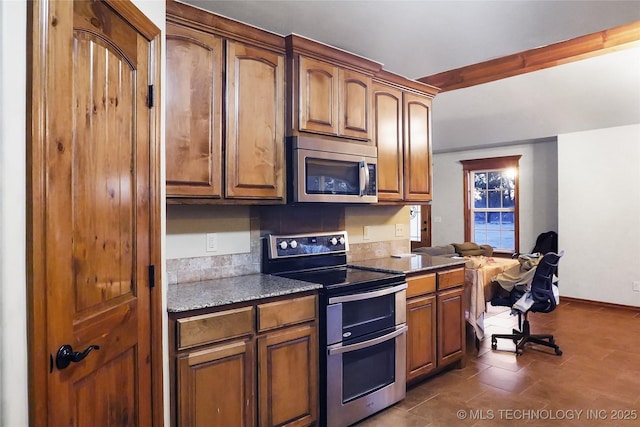 740384 S 3480th Rd, Cushing, OK 74023 - kitchen with stainless steel appliances, brown cabinetry, and dark stone counters