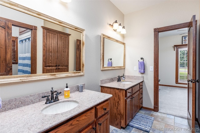 214 Kernel, Durant, OK 74701 - full bathroom featuring two vanities and stone finish floors
