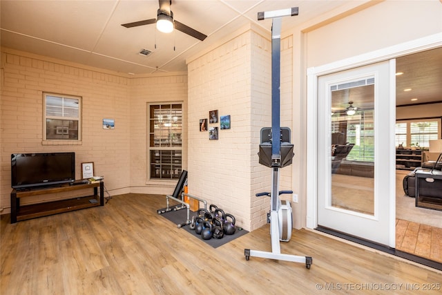 214 Kernel, Durant, OK 74701 - exercise area featuring a ceiling fan, wood finished floors, and brick wall