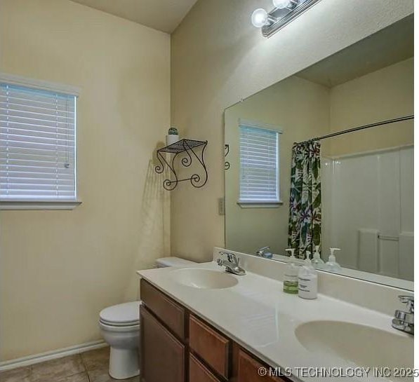 203 E 125th Pl S, Jenks, OK 74037 - full bathroom featuring double vanity, tile patterned flooring, a shower with curtain, and plenty of natural light