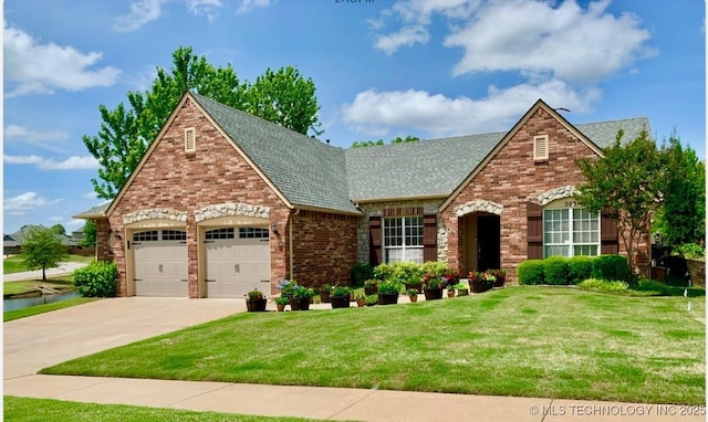 203 E 125th Pl S, Jenks, OK 74037 - tudor-style house featuring a garage, a front yard, driveway, brick siding, and a shingled roof