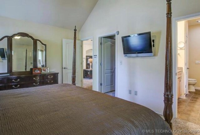 203 E 125th Pl S, Jenks, OK 74037 - tiled bedroom featuring vaulted ceiling and ensuite bath