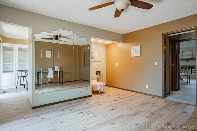 32 SE Shadowlake Dr Unit 32, Bartlesville, OK 74006 - bathroom with a ceiling fan, wood finished floors, and a textured ceiling