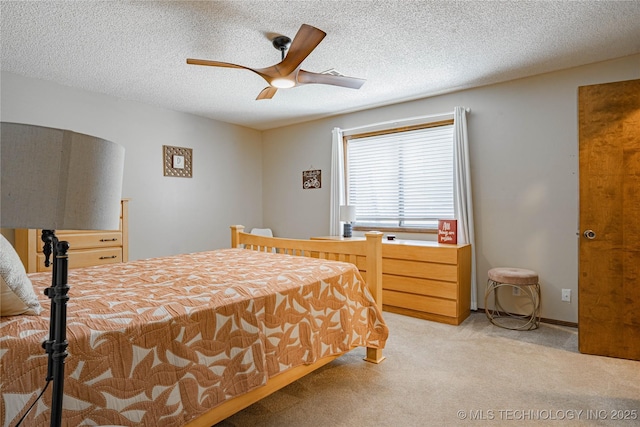 32 SE Shadowlake Dr Unit 32, Bartlesville, OK 74006 - bedroom with light colored carpet, a textured ceiling, and ceiling fan