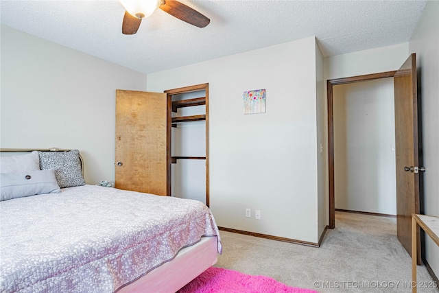 32 SE Shadowlake Dr Unit 32, Bartlesville, OK 74006 - bedroom with light colored carpet, a closet, ceiling fan, and a textured ceiling