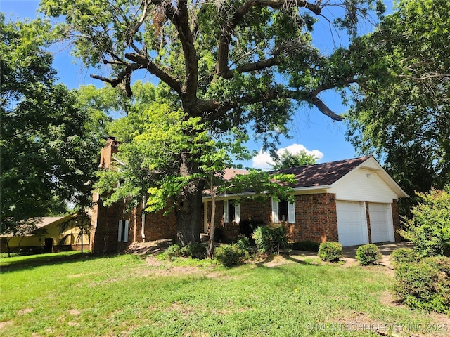 1181 Deer Crk, Pryor, OK 74361 - view of front of house featuring a front lawn, brick siding, and a garage