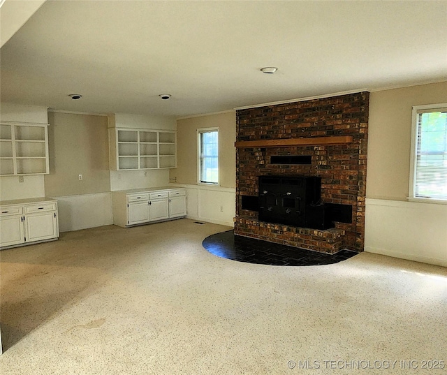 1181 Deer Crk, Pryor, OK 74361 - unfurnished living room with healthy amount of natural light and a fireplace