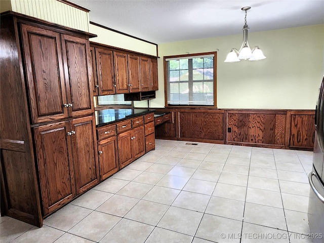 1181 Deer Crk, Pryor, OK 74361 - kitchen featuring a chandelier, a wainscoted wall, decorative light fixtures, dark countertops, and dark brown cabinetry