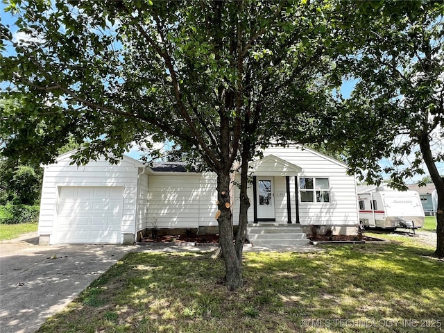 1424 S Penn Ave, Bartlesville, OK 74003 - view of front of house with a garage, driveway, and a front yard