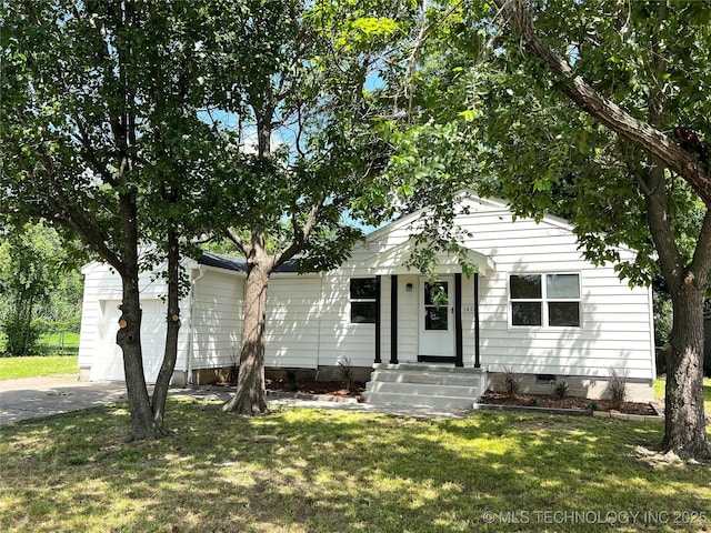 1424 S Penn Ave, Bartlesville, OK 74003 - view of front of home with driveway, a front yard, crawl space, and a garage