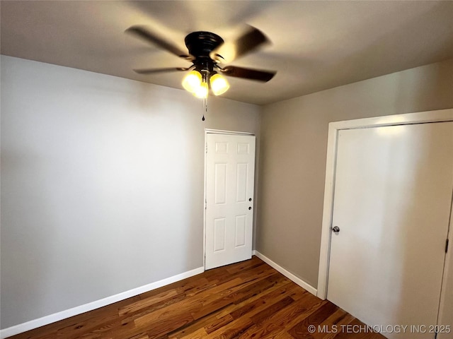 1424 S Penn Ave, Bartlesville, OK 74003 - unfurnished bedroom with dark wood-type flooring and a ceiling fan