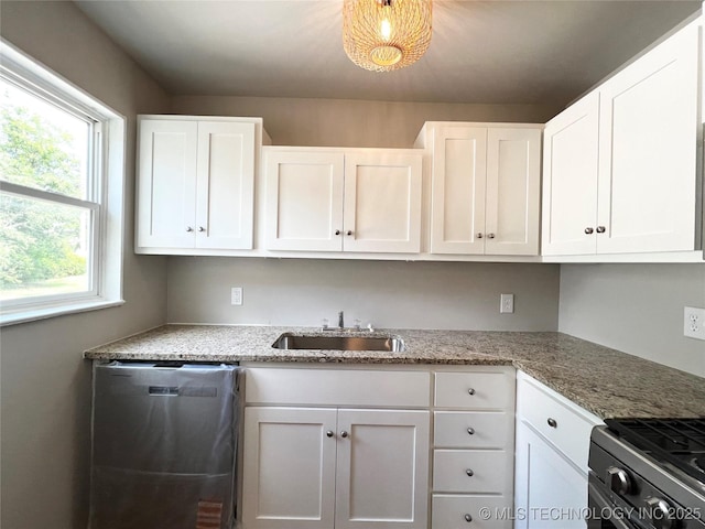1424 S Penn Ave, Bartlesville, OK 74003 - kitchen featuring appliances with stainless steel finishes, white cabinetry, and light stone counters