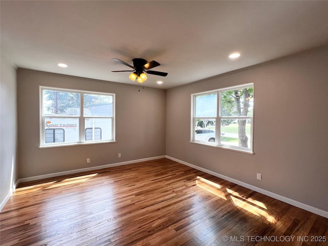 1424 S Penn Ave, Bartlesville, OK 74003 - unfurnished room featuring healthy amount of natural light, wood finished floors, a ceiling fan, and recessed lighting
