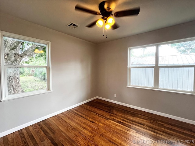 1424 S Penn Ave, Bartlesville, OK 74003 - empty room featuring dark wood-type flooring and a ceiling fan