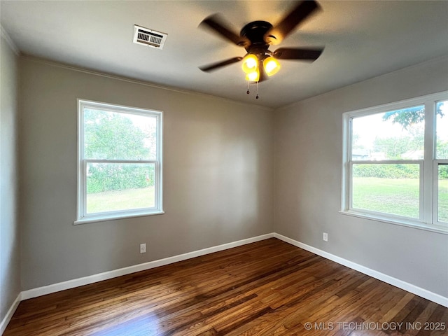1424 S Penn Ave, Bartlesville, OK 74003 - unfurnished room featuring dark wood-type flooring, plenty of natural light, a ceiling fan, and ornamental molding