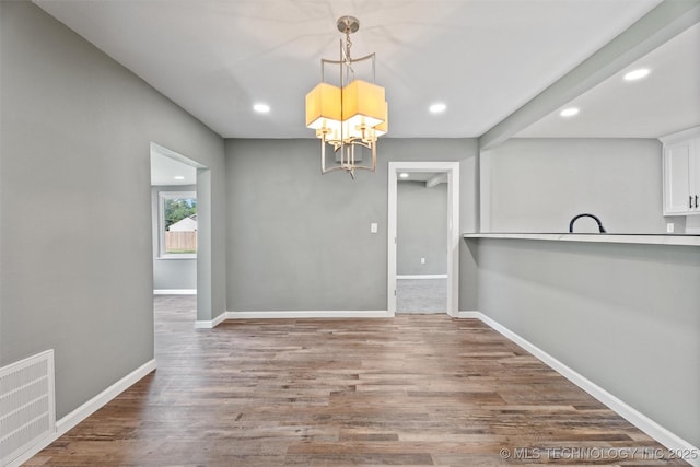 202 N Creek, Dewey, OK 74029 - unfurnished dining area featuring recessed lighting, a chandelier, and wood finished floors