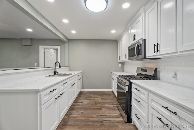 202 N Creek, Dewey, OK 74029 - kitchen with stainless steel appliances, a peninsula, backsplash, dark wood-type flooring, and recessed lighting