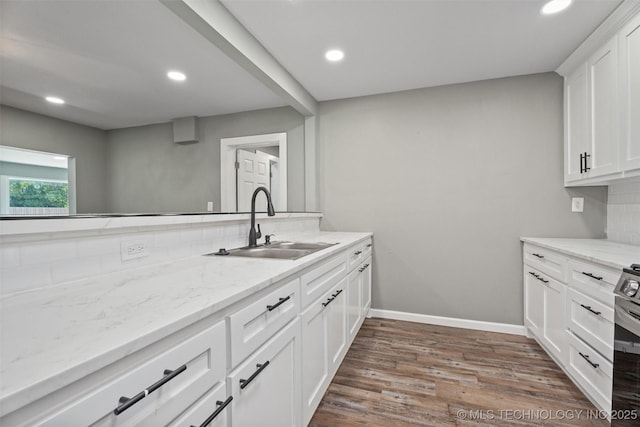 202 N Creek, Dewey, OK 74029 - kitchen featuring wood finished floors, recessed lighting, white cabinetry, light stone countertops, and backsplash