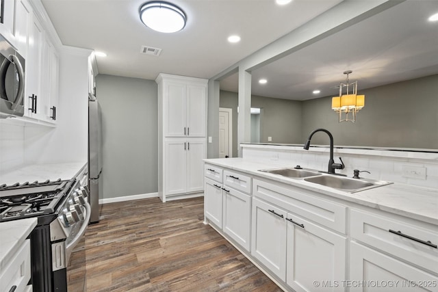 202 N Creek, Dewey, OK 74029 - kitchen featuring stainless steel appliances, white cabinetry, tasteful backsplash, dark wood finished floors, and recessed lighting