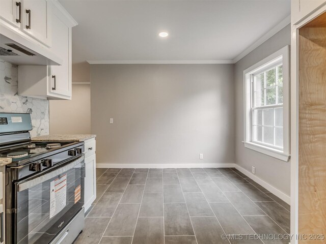 3226 N Garrison Ave, Tulsa, OK 74106 - kitchen featuring black stove, under cabinet range hood, ornamental molding, decorative backsplash, and light stone countertops