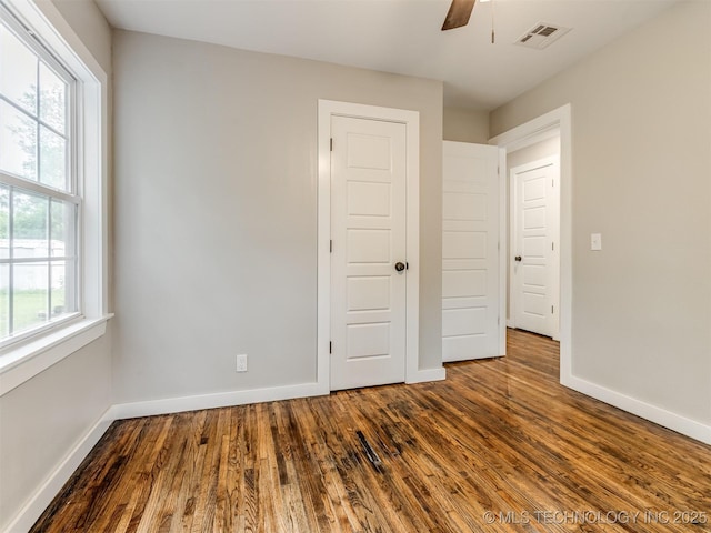 3226 N Garrison Ave, Tulsa, OK 74106 - unfurnished bedroom featuring dark wood finished floors and a ceiling fan