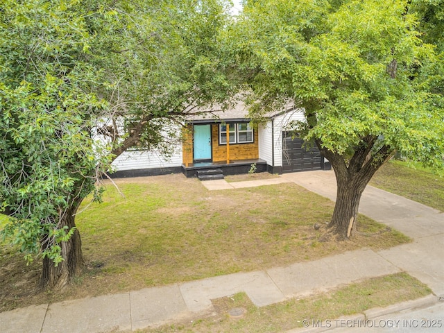 3226 N Garrison Ave, Tulsa, OK 74106 - view of front of house featuring a front lawn, driveway, and an attached garage